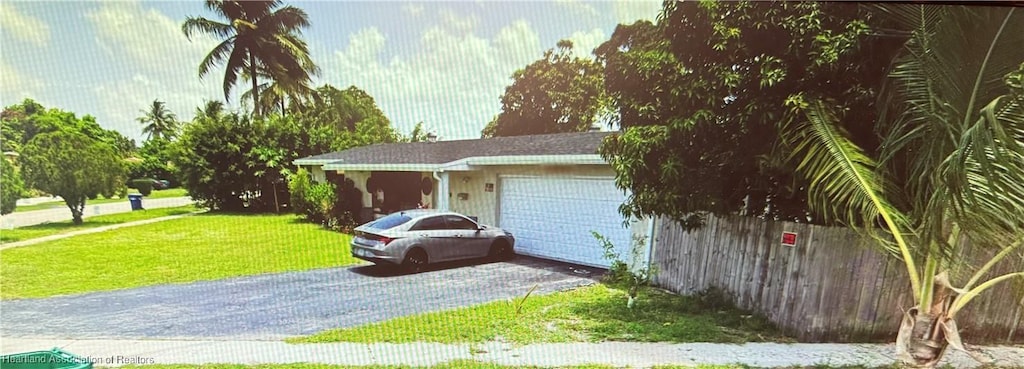 garage featuring a lawn