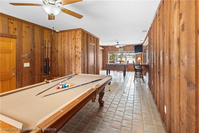 rec room with a ceiling fan, visible vents, tile patterned floors, wooden walls, and billiards