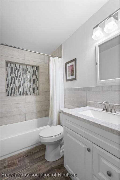 full bath featuring toilet, tile walls, shower / tub combo with curtain, vanity, and wood finished floors