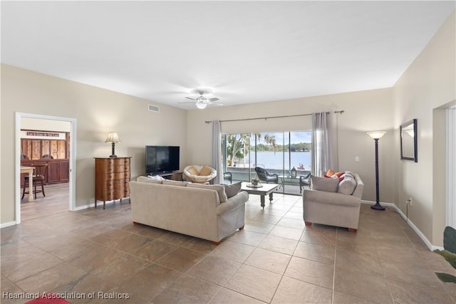 living area with visible vents, baseboards, and a ceiling fan