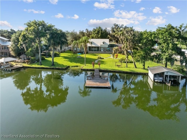 dock area with a water view and a yard