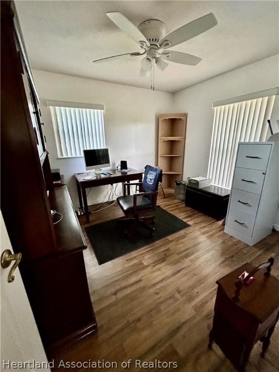 office space with hardwood / wood-style floors and ceiling fan