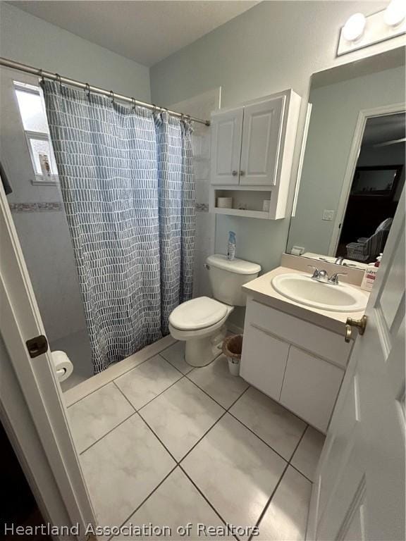 bathroom featuring toilet, tile patterned flooring, vanity, and a shower with shower curtain