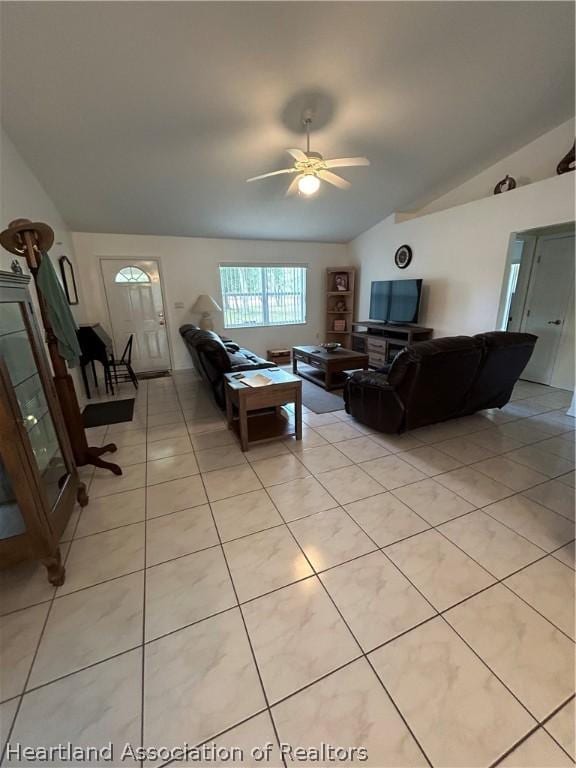 living room with vaulted ceiling, ceiling fan, and light tile patterned flooring