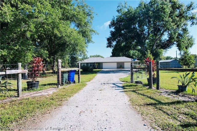 view of front facade with a garage and a front lawn