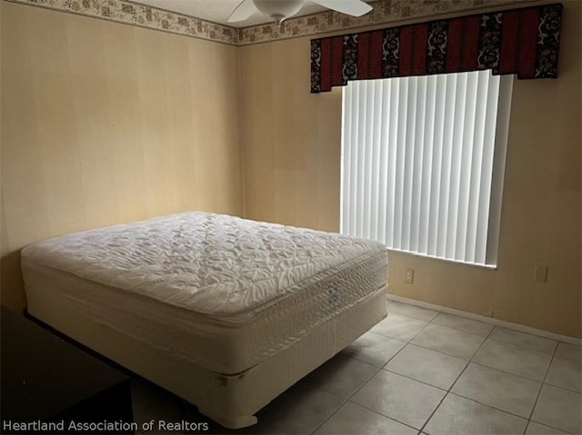 tiled bedroom with ceiling fan