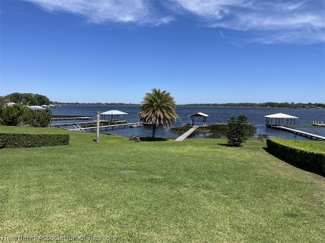 exterior space featuring a dock and a water view