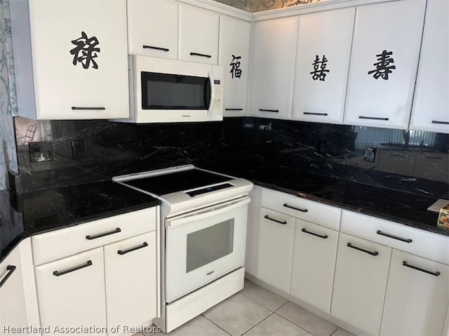 kitchen featuring backsplash, white cabinets, light tile patterned flooring, and white appliances