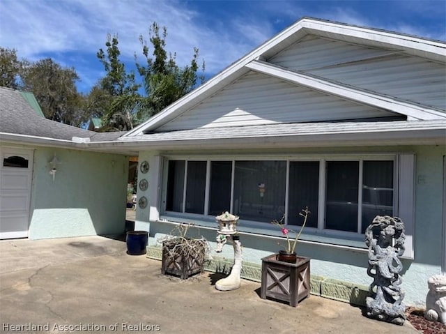 rear view of house with a garage