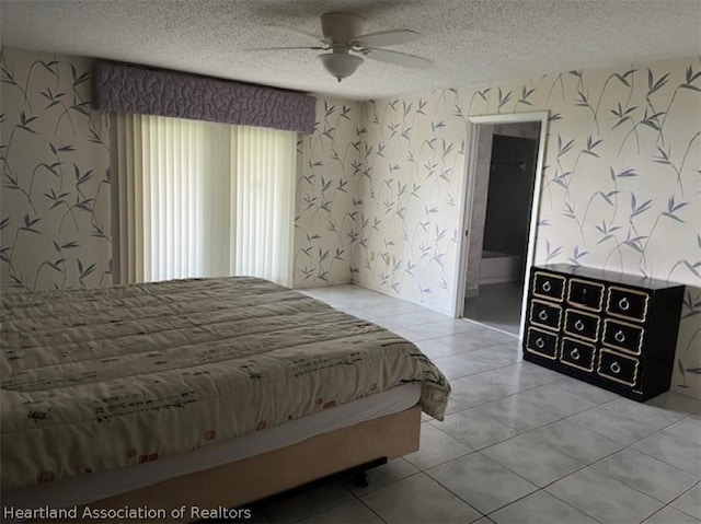 tiled bedroom featuring a textured ceiling and ceiling fan