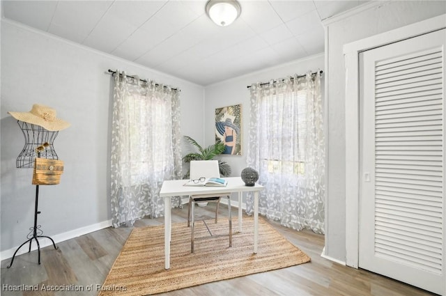 office area featuring hardwood / wood-style flooring and ornamental molding