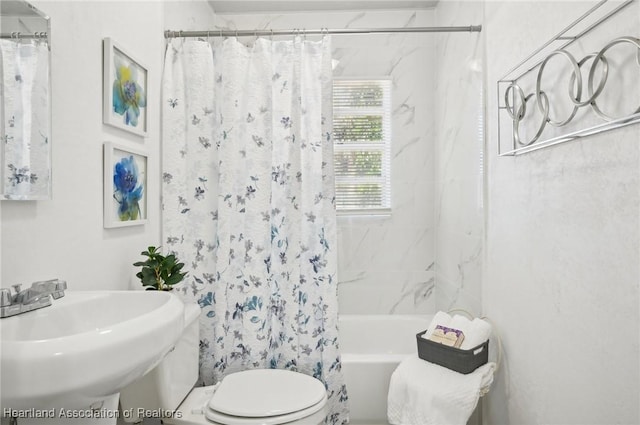 full bathroom featuring shower / tub combo, toilet, and sink