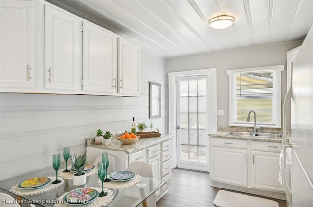 kitchen featuring white cabinets, white fridge, and sink