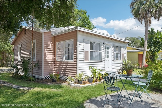 view of side of home with a lawn