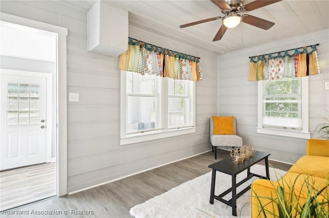 sitting room with hardwood / wood-style floors, ceiling fan, and a healthy amount of sunlight