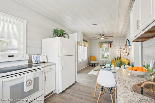 kitchen featuring light hardwood / wood-style floors, ceiling fan, white cabinetry, and white appliances