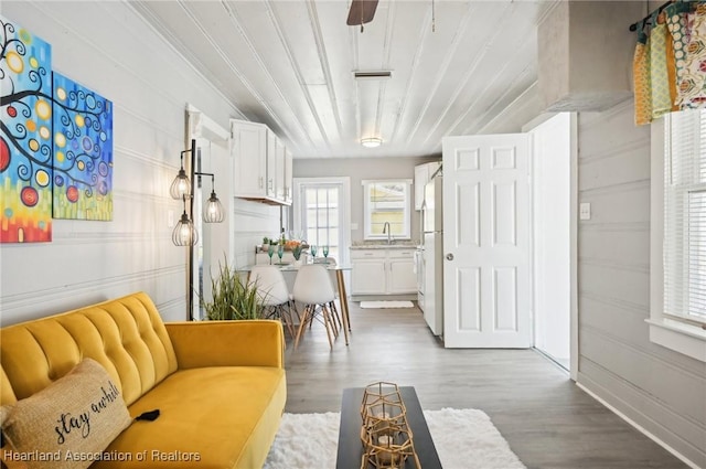 interior space with hardwood / wood-style flooring, ceiling fan, and sink