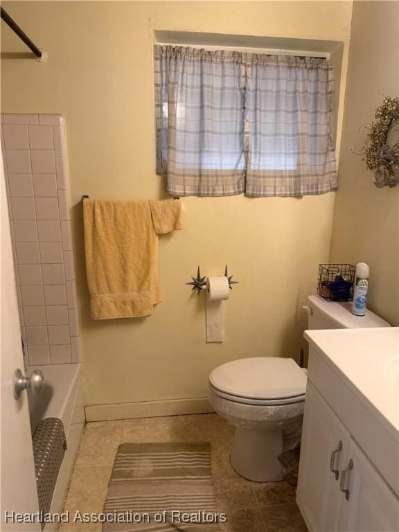 bathroom featuring toilet, vanity, and tile patterned floors