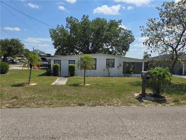 ranch-style home featuring a front yard