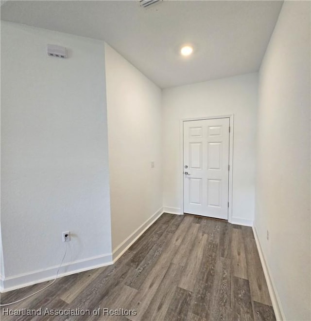 3040 W Joliet Rd, Avon Park, FL 33825 - hall with dark wood-style flooring and baseboards