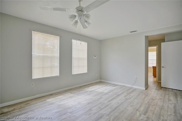 empty room featuring ceiling fan and light hardwood / wood-style floors