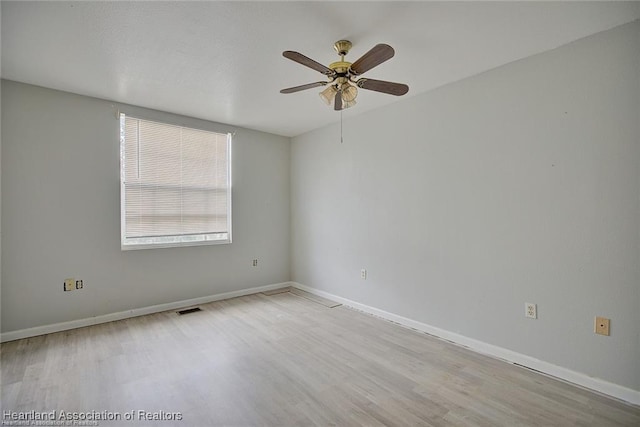 spare room with light hardwood / wood-style floors and ceiling fan