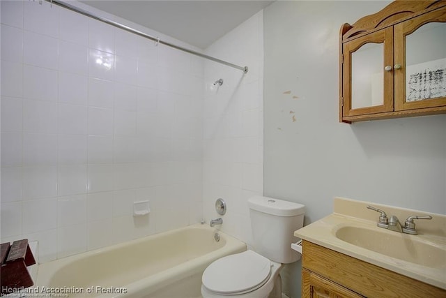 full bathroom featuring vanity, toilet, and tiled shower / bath