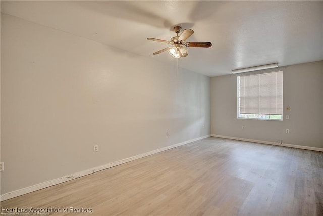 spare room with light hardwood / wood-style floors and ceiling fan