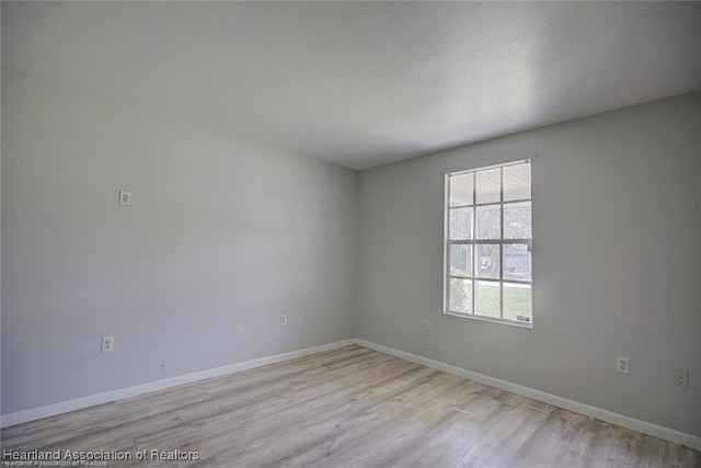 unfurnished room featuring light wood-type flooring