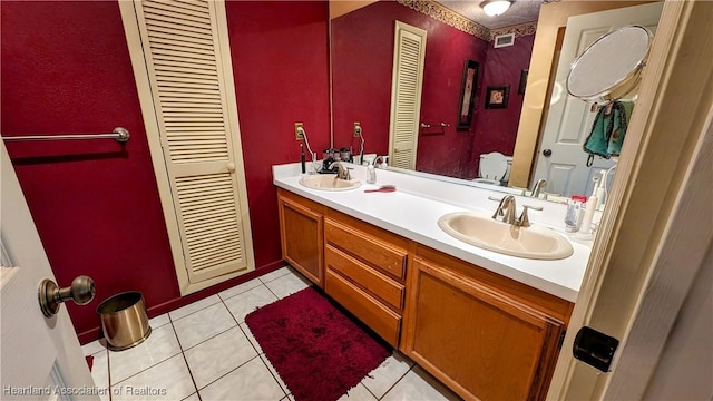 bathroom with tile patterned floors, vanity, and toilet