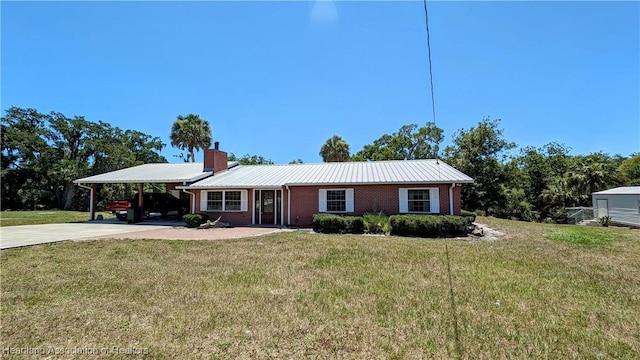 ranch-style home with a front yard and a carport