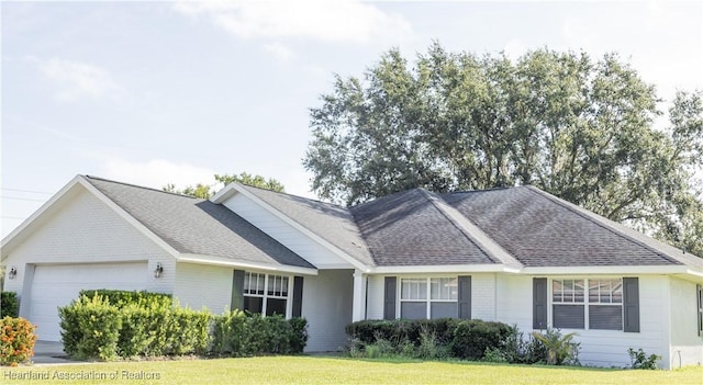 2992 Oaks Bnd, Bowling Green, FL 33834 - view of front of home featuring brick siding, an attached garage, roof with shingles, and a front yard