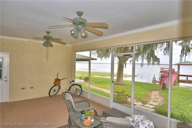 unfurnished sunroom with a water view and ceiling fan