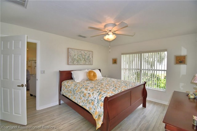 bedroom featuring light wood-style floors, baseboards, and visible vents