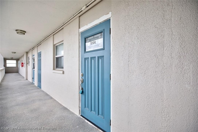 property entrance featuring stucco siding