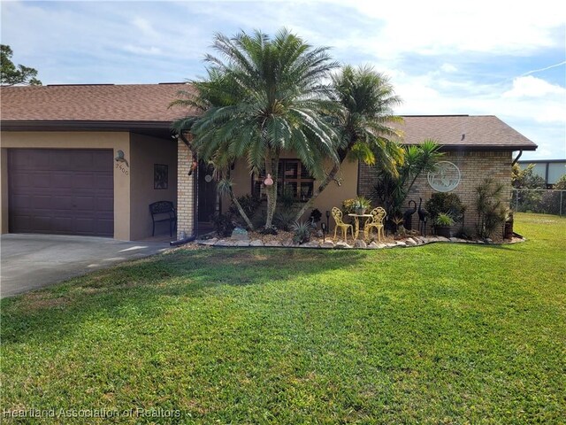 ranch-style home with a garage and a front lawn