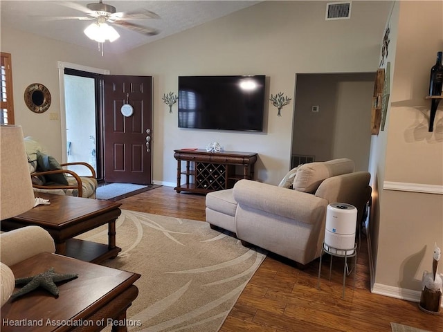 living room with ceiling fan, wood-type flooring, and vaulted ceiling