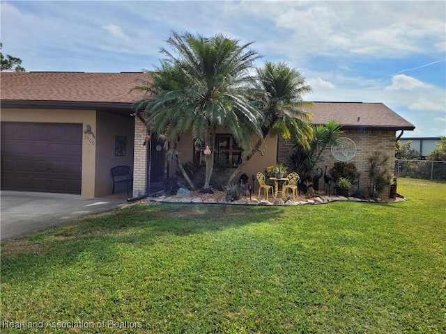 view of front of house with a garage and a front yard