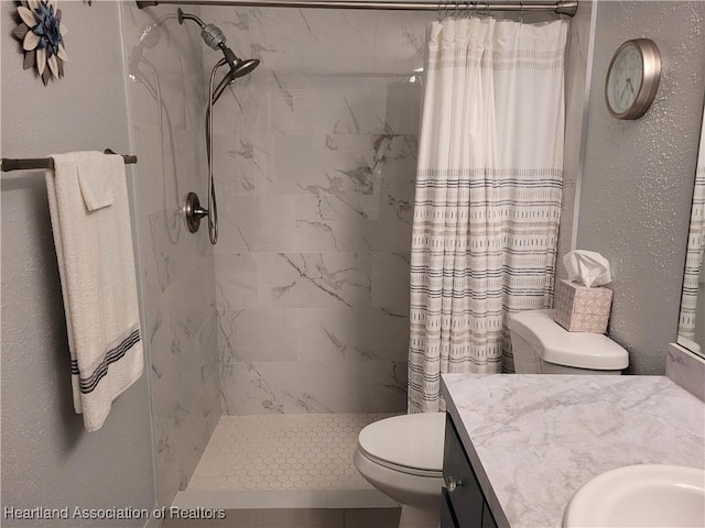 bathroom featuring vanity, toilet, and a shower with shower curtain