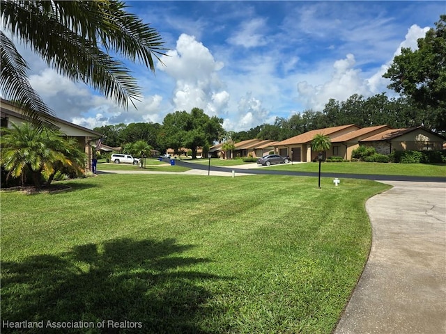 view of property's community with a yard