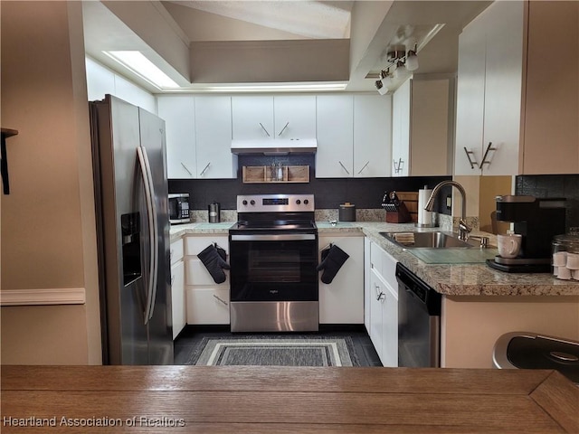 kitchen with white cabinets, appliances with stainless steel finishes, and sink