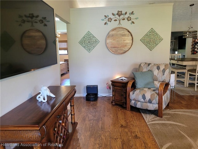 living area featuring dark hardwood / wood-style floors and a textured ceiling