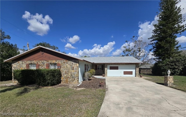 ranch-style home featuring a garage and a front lawn