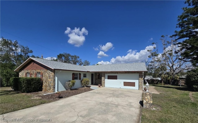 ranch-style home with a garage and a front lawn