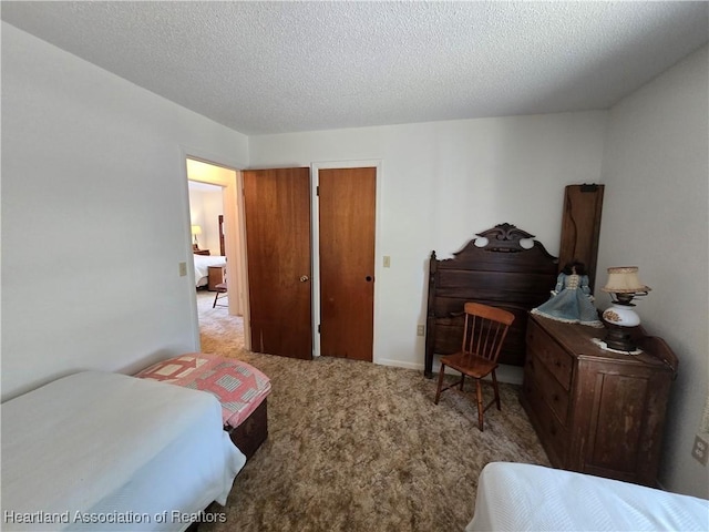 carpeted bedroom featuring a textured ceiling