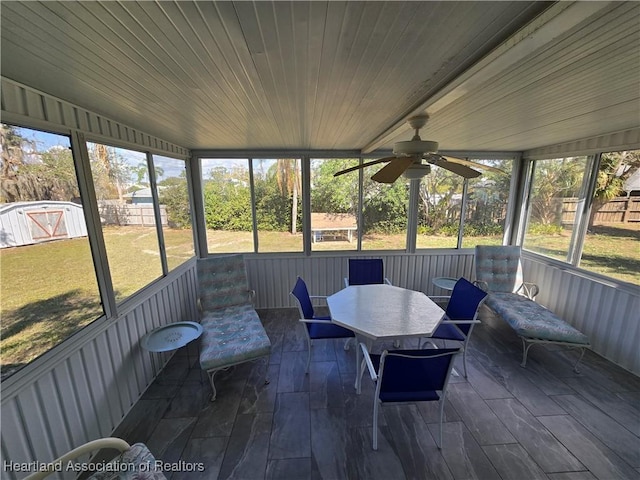 sunroom featuring wooden ceiling and ceiling fan