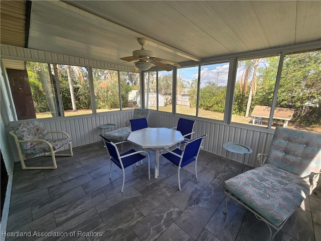 sunroom / solarium with wood ceiling and ceiling fan