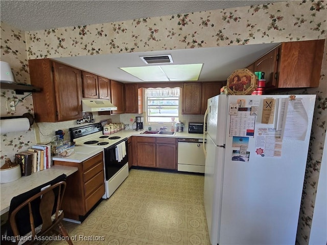 kitchen featuring white appliances and sink