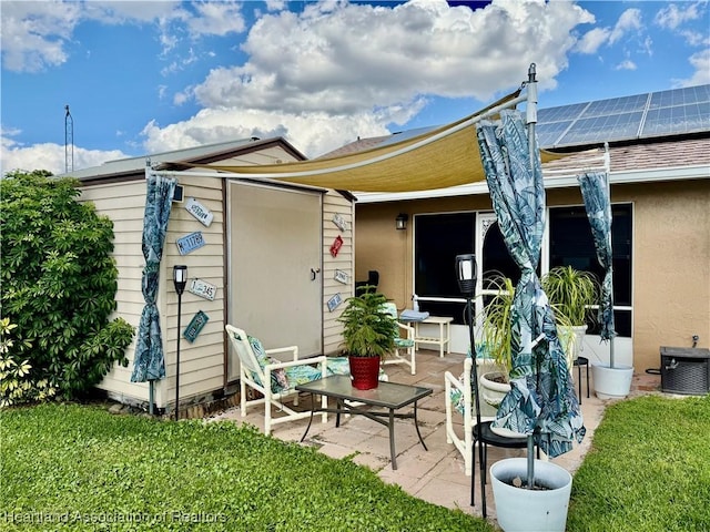 rear view of property featuring solar panels, a patio area, and cooling unit