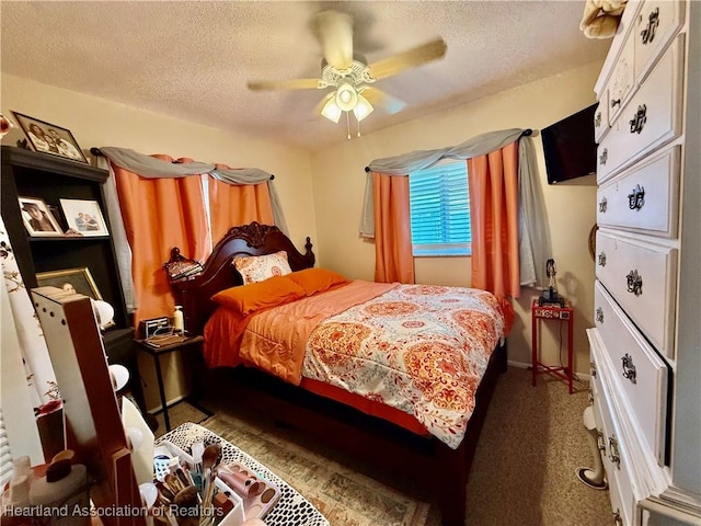 carpeted bedroom featuring a ceiling fan and a textured ceiling